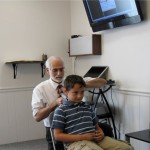 Dr. Brown shown taking a scan along a child's neck